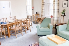 John McDouall Stuart View - Living / Dining area with view of armchair and dining table
